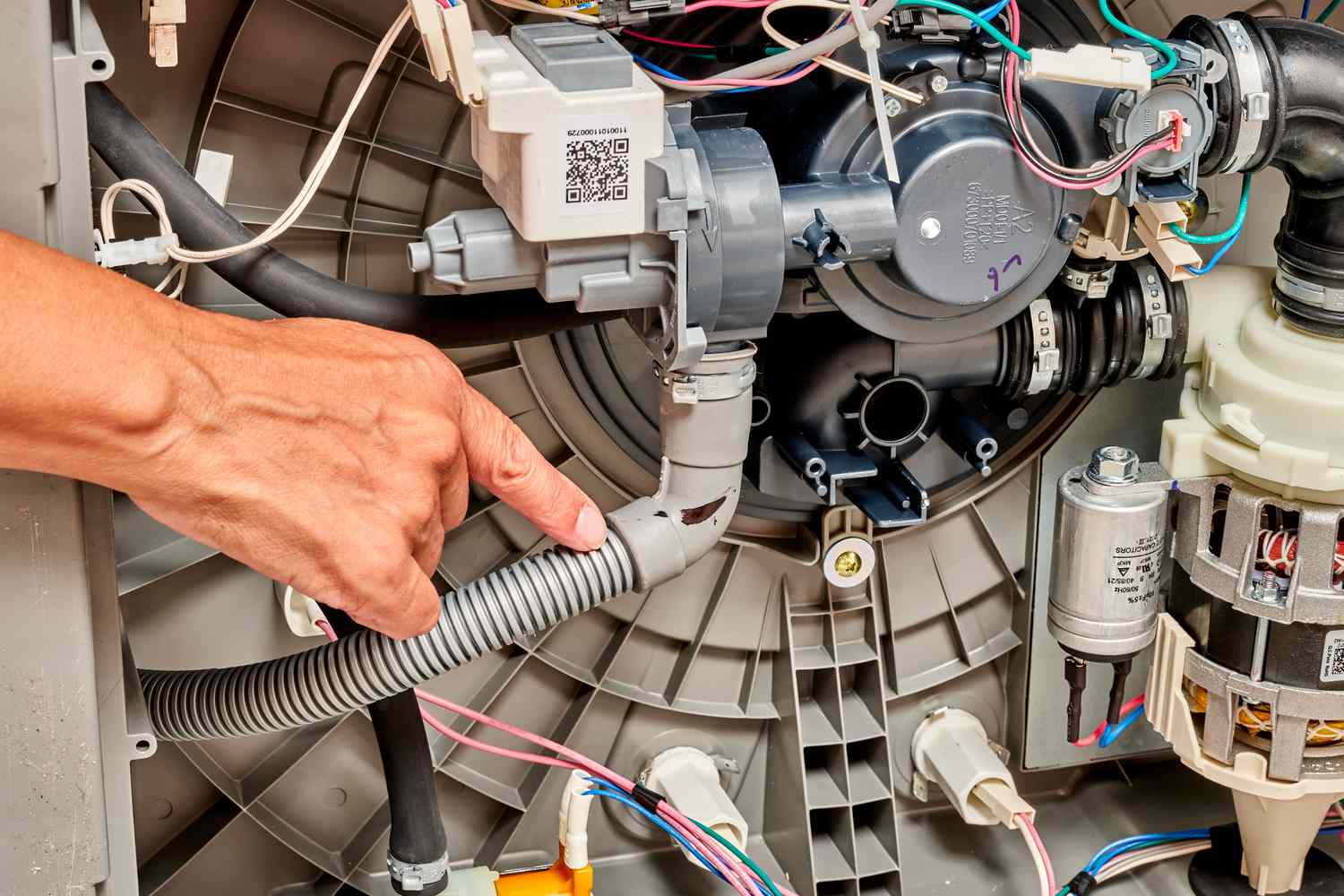 Technician diagnosing issues in a malfunctioning dishwasher